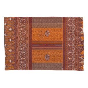 a cross stitch pattern in orange and brown pillow case