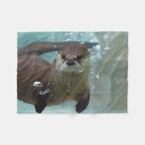 A cute Brown otter swimming in a clear blue pool Fleece Blanket