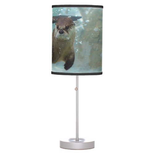 A cute Brown otter swimming in a clear blue pool Table Lamp