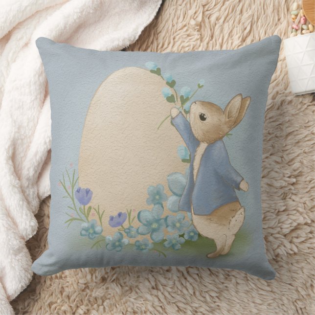 A cute bunny in a blue suit paints an Easter egg Throw Pillow (Blanket)