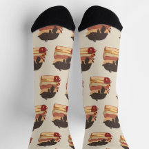 A cute kitten sleeping curled up on a pile of book