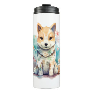 A cute well-behaved dog in a floral thermal tumbler