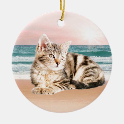 A Cuter Striped Cat Sitting on Beach with sunset Ceramic Ornament