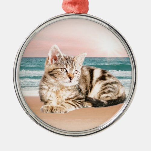 A Cuter Striped Cat Sitting on Beach with sunset Metal Ornament