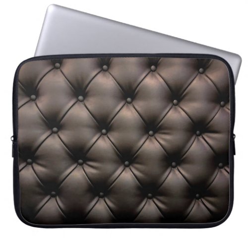 A dark leather cushion background from a car seat laptop sleeve