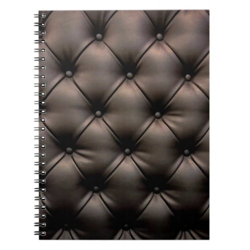 A dark leather cushion background from a car seat notebook