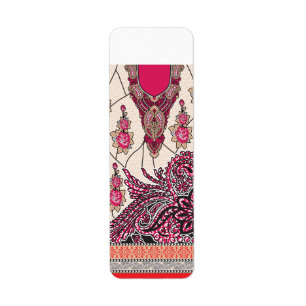 A decorative paisley design with vivid red and pin label