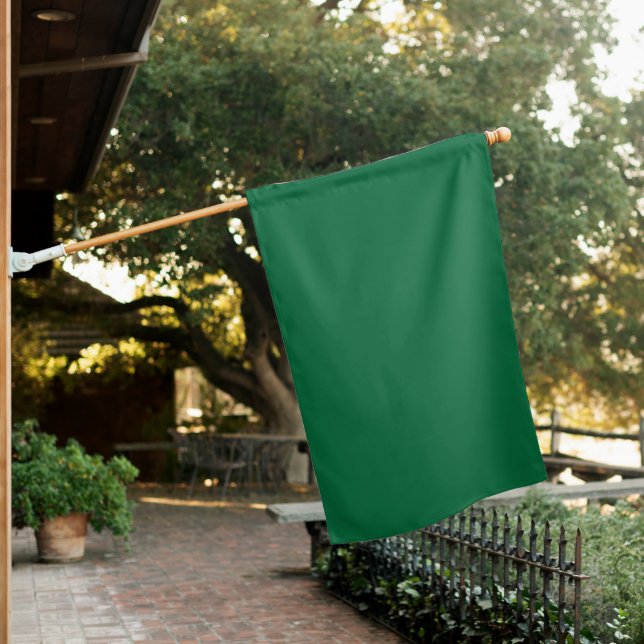 A deep green background contrasted by a crisp whit house flag (In SItu)