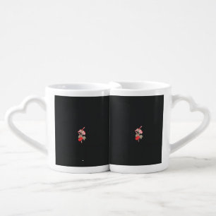 a design of a red flower on a white background coffee mug set
