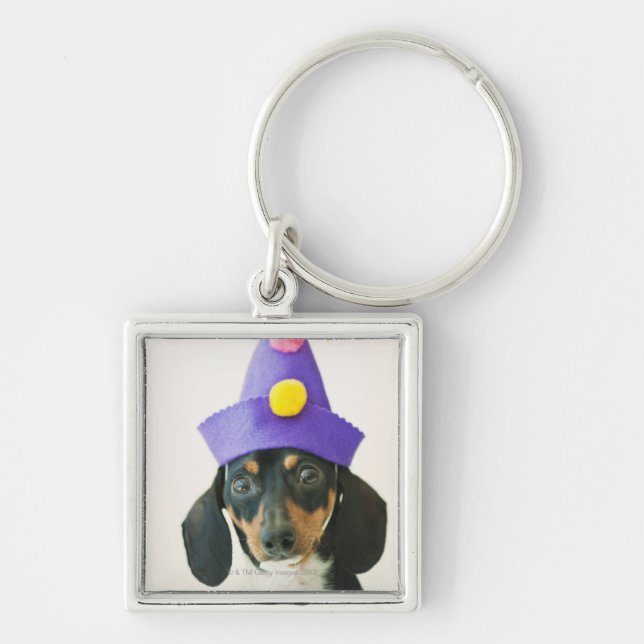 A dog wearing a funny hat keychain (Front)