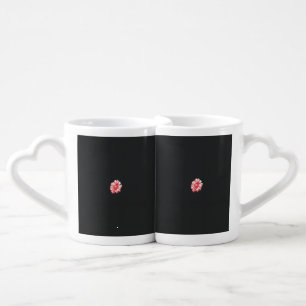 a drawing of a red flower on a white background coffee mug set