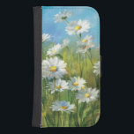 A Field of White Daisies Phone Wallet<br><div class="desc">© Danhui Nai / Wild Apple.  An image of a field of white daisies and tall grass. A clear blue sky can be viewed in the background.</div>