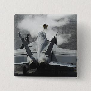 A flight deck director signals an F/A-18F Pinback Button