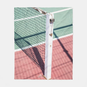 A FOCUSED SHOT OF A POST ON ONE SIDE OF A TENNIS N FLEECE BLANKET