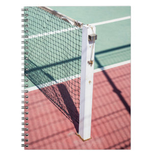 A FOCUSED SHOT OF A POST ON ONE SIDE OF A TENNIS N NOTEBOOK