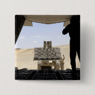 A forklift loads cargo onto a C-130 Hercules Button