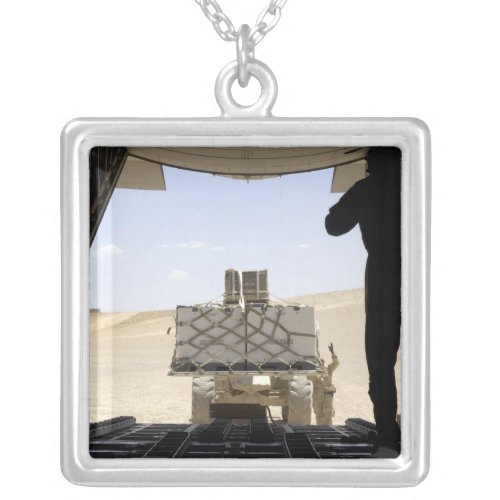 A forklift loads cargo onto a C_130 Hercules Silver Plated Necklace