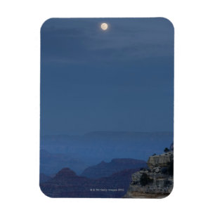 A full moon rises through a dusk sky at Hopi Magnet