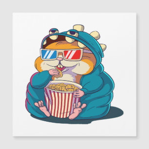 A funny hamster wearing glasses eats popcorn