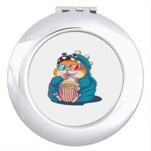 A funny hamster wearing glasses eats popcorn compact mirror
