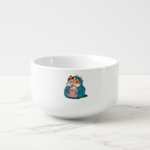 A funny hamster wearing glasses eats popcorn soup mug