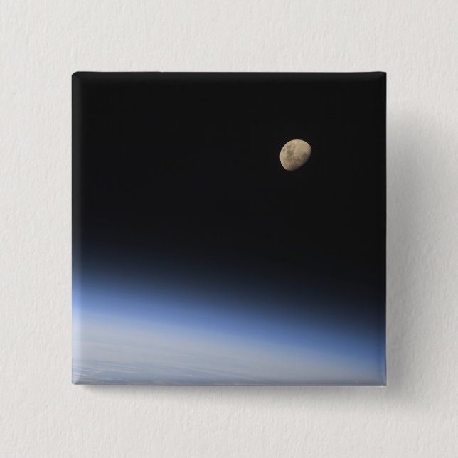 A gibbous moon visible above Earth's atmosphere Button (Front)