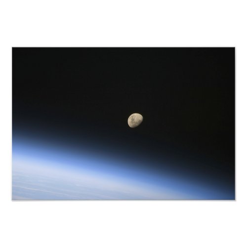 A gibbous moon visible above Earths atmosphere Photo Print