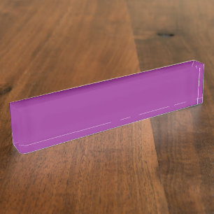 A gradient background blending shades of pink and  desk name plate