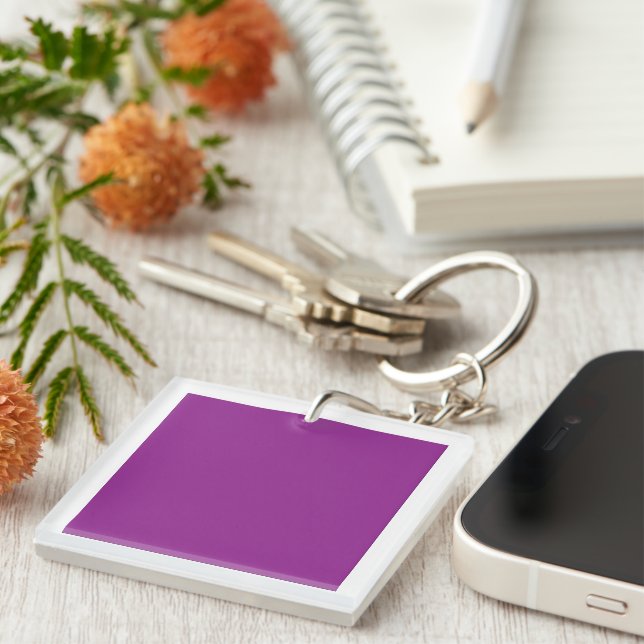 A gradient background blending shades of pink and  keychain (Front Right)