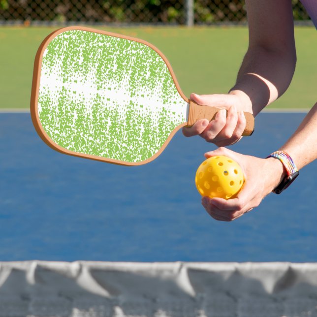 a green and white background with small dots carbon fiber pickleball paddle  (Insitu)