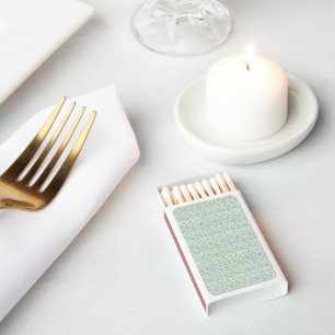 a green and white background with small leaves matchboxes