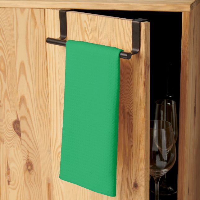 a green background with a kitchen towel (Thirds Fold)