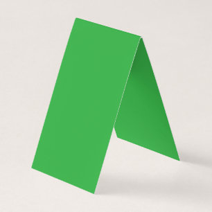 a green background with a white border business card