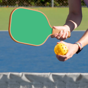 a green background with a white border carbon fiber pickleball paddle 