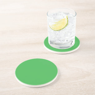 a green background with a white border coaster