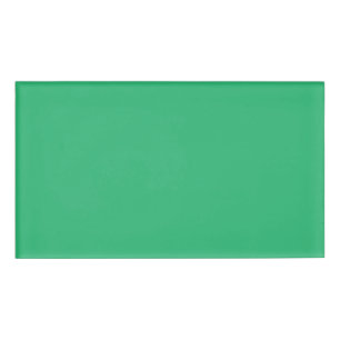 a green background with a white border name tag