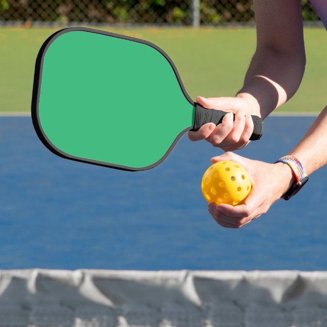 a green background with a white border pickleball paddle (Insitu)