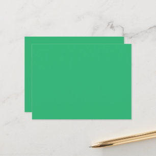 a green background with a white border postcard