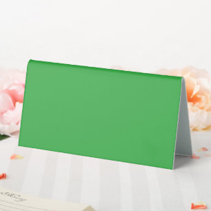 a green background with a white border table tent