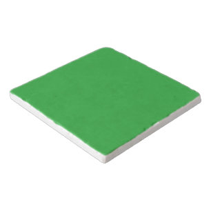 a green background with a white border trivet