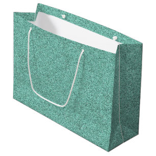 A green glitter gift bag with white handles