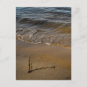 A heart on sand and in rainbow colors postcard