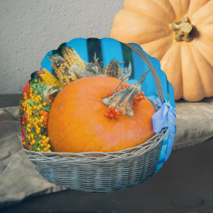 A holiday basket with pumpkins round pillow