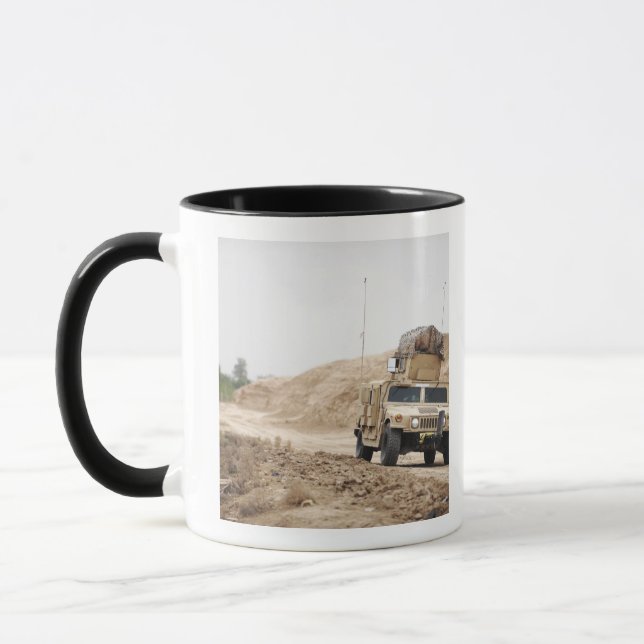 A Humvee conducts security Mug (Left)