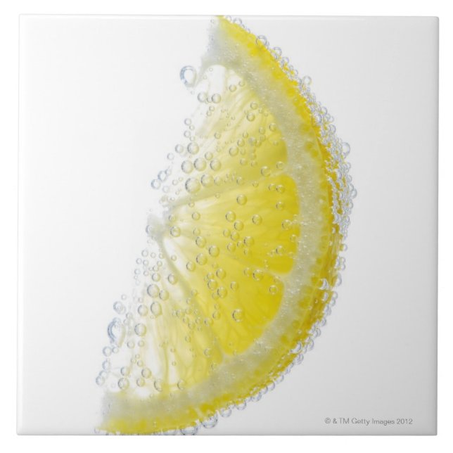 A juicy ripe organic lemon wedge fruit submerged ceramic tile (Front)