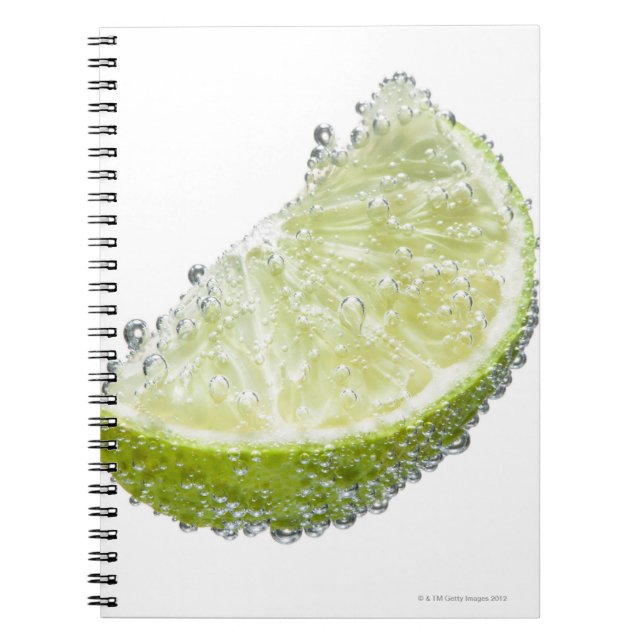 A juicy ripe organic lime wedge fruit submerged notebook (Front)