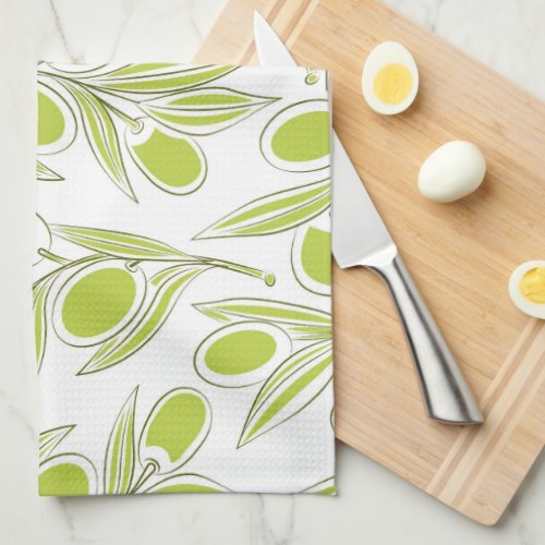 A kitchen towel with a vibrant olive branch print