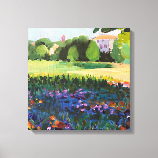 A landscape with a field in bloom and city canvas print