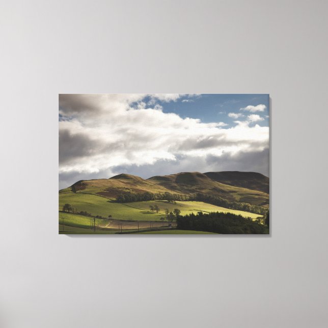 A Landscape With Rolling Hills And Clouds Overhead Canvas Print (Front)