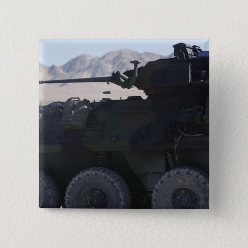A light armored vehicle fires pinback button